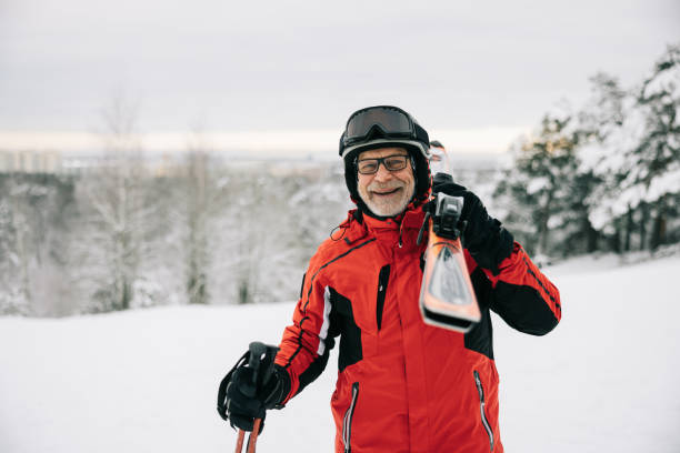 istock Portrait of active senior man with skis on shoulder 1906790920