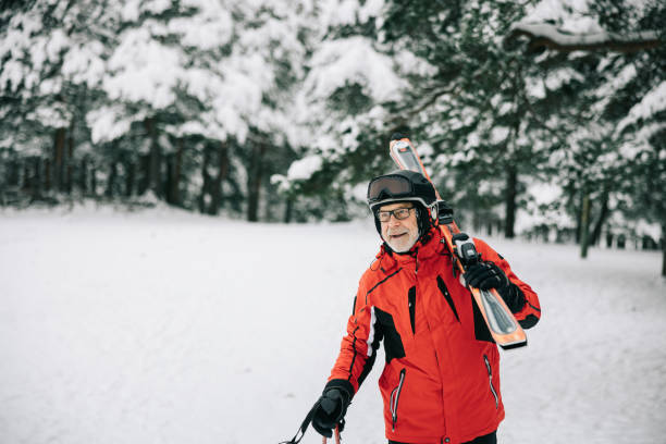 istock Active senior man walks with skis on his shoulder 1906790927
