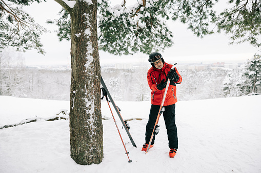 Senior man embraces the art of ski maintenance, waxing his equipment with precision