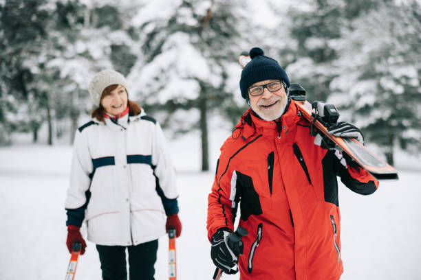 istock Smiling senior couple going skiing together 1906790933