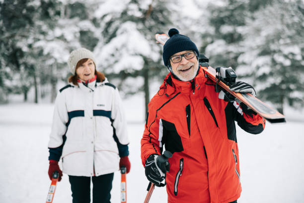 istock Smiling senior couple going skiing together 1906790934