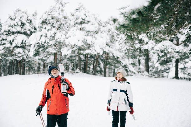 istock Smiling senior couple going skiing together 1906791469