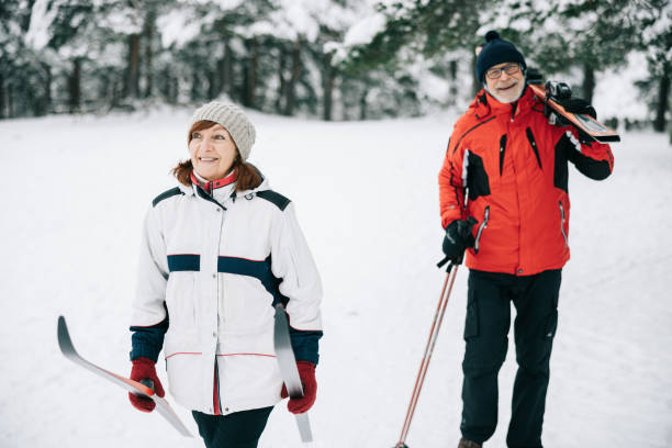istock Smiling senior couple going skiing together 1906791470