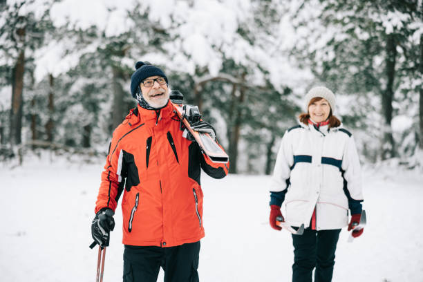 istock Smiling senior couple going skiing together 1906791472