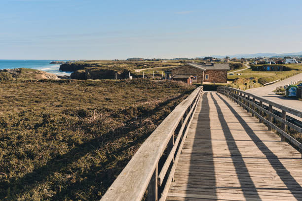 istock Wooden pedestrian boardwalk leading along beach. Spain 1906794110