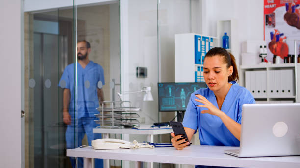 istock Nurse holding smartphone talking to patient making telemedicine 1906798953