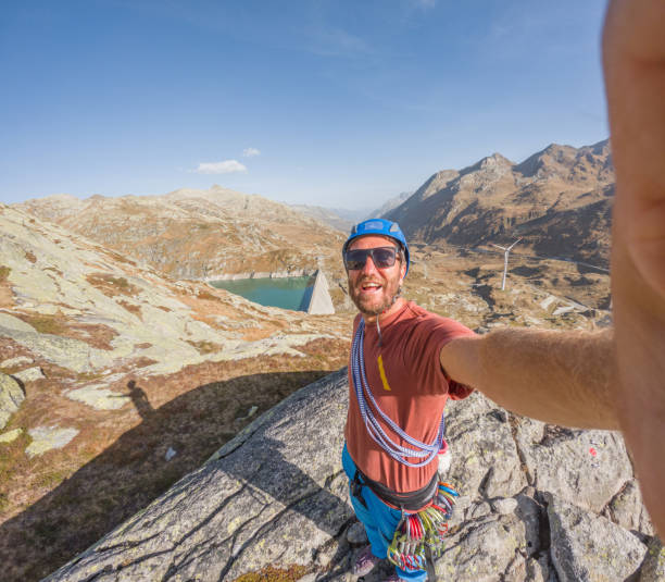 istock Rock climber takes cool selfie from mountain top 1906799992
