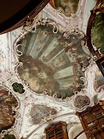 Abbey library of Saint Gall is a significant medieval monastic library located in St. Gallen, Switzerland. In 1983, the library, as well as the Abbey of St. Gall, were designated a World Heritage Site. the image shows the ceiling of the main room of the library.