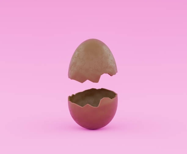 istock Chocolate Egg Opened in Two Halves on a Pink Background 1906817280