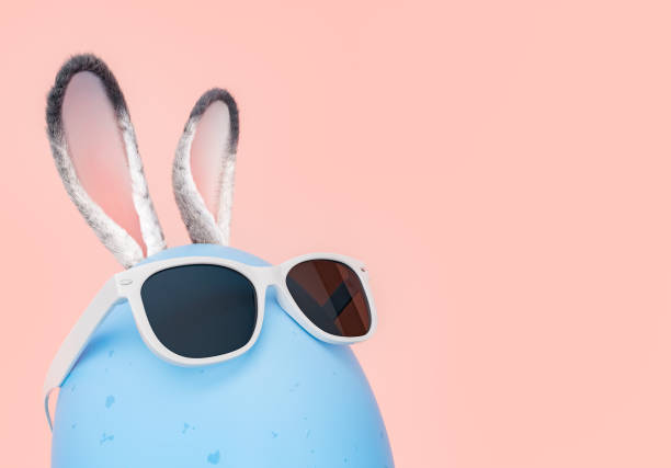 istock Cool Easter Egg with Bunny Ears and Sunglasses on Pink Background 1906817283