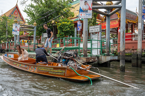 Nonthaburi is a district in Bangkok.\nThis district is located west of the Chao Phraya River. \nNonthaburi is known for its khlongs or canals that run through the residential areas.\nThe picture shows transit boats or taxi boats taking passengers to their destinations on the Khlongs.\nBangkok in Thailand Asia\n01/04/2024