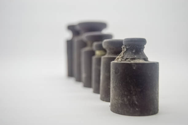 istock weights ancient scales arranged from small to large isolated on a white background. perfect for economics, finance and business articles 1906831517