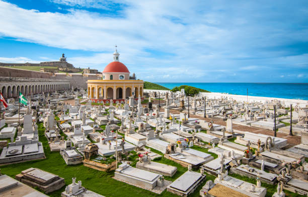 Travel image of old cemetery with graves at the coastline of San Juan, Puerto Rico. Old fortress in the background.