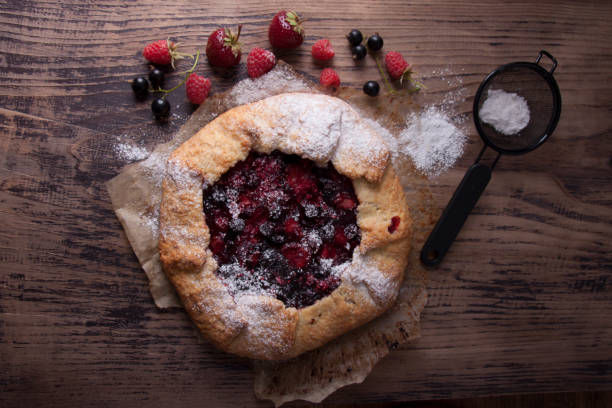 istock Galette with berries raspberries, strawberries and black currants with sugar powder 1906847623