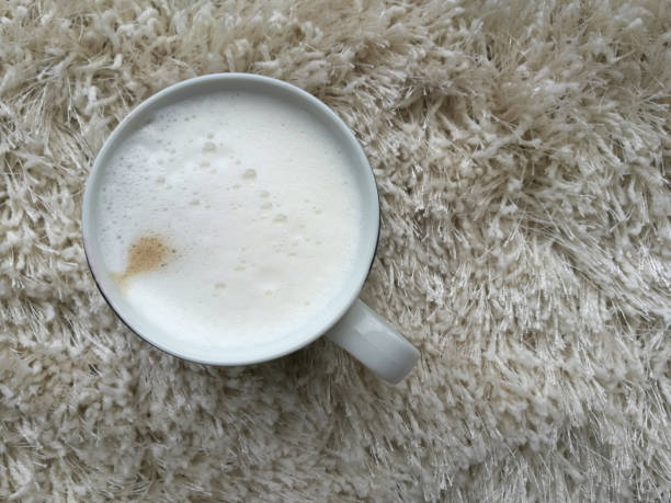 Coffee in a black mug on a fluffy carpet
