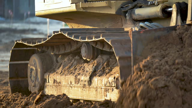 Bulldozer moving dirt at construction site