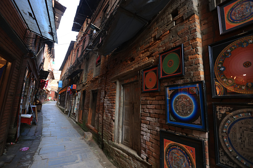 Kathmandu, Nepal - November 25 2023: artist work in Thangka stores is opened in Bhaktapur Durbar square. Thangka is a tradiitional tibetan buddhist painting, usually depicting a buddhist deity