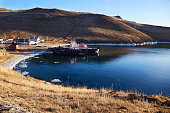 Ferries for the transportation of passengers at the pier of Olkhon Island on a December day. Unfrozen Lake Baikal