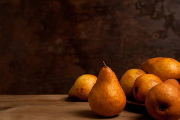 istock Pears on wooden background as background image. 1906897581