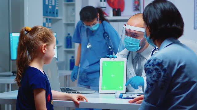 Doctor using green screen tablet