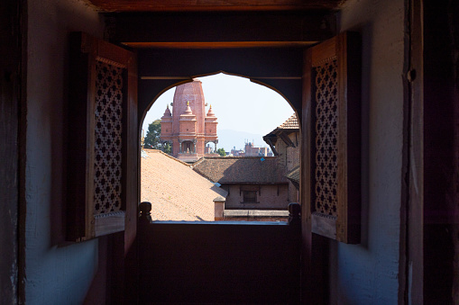watch outside though Newar window window having the view of temple of Silu Mahadeva in Bhaktapur durbar square