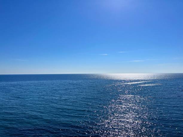 istock Blue sea glittering water and clear sky on horizon 1906904398