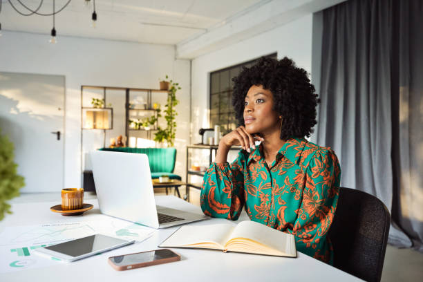 istock Thoughful woman working on laptop in an office 1906912584