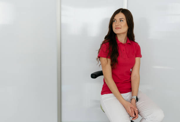 istock Dental assistant in exam room smiling 1906913959