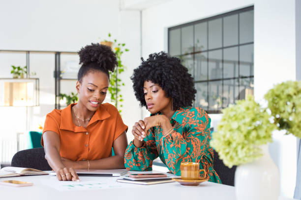 istock Two black women working together in the office 1906923486