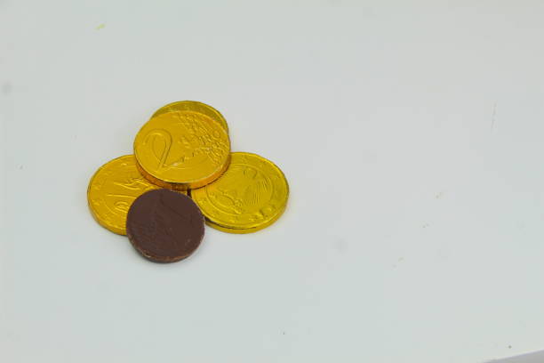 istock Holden wrapped chocolate coins on a white surface 1906929807