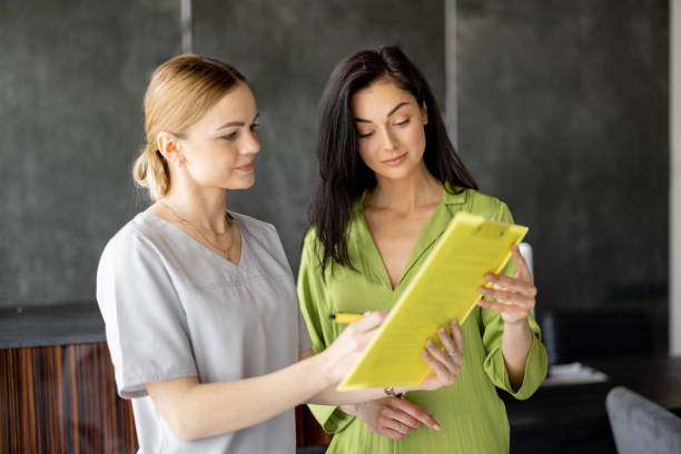 istock Nurse talks with a woman in lobby 1906931381