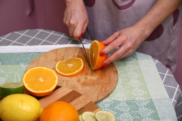 istock A person cutting oranges on a cutting board 1906945945