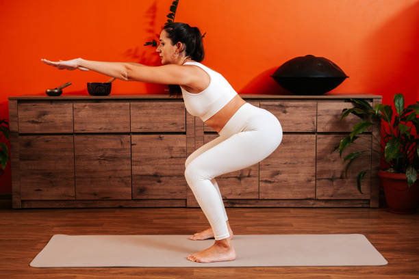 istock Beautiful young woman doing sport exercise at home. 1906948592