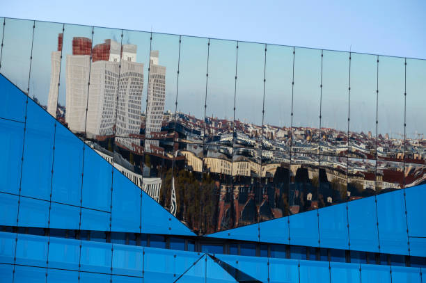 Berlin, Germany - 18. November 2022: The city skyline of Berlin is reflected in the glass façade of the modern office building The Cube at the main railway station.