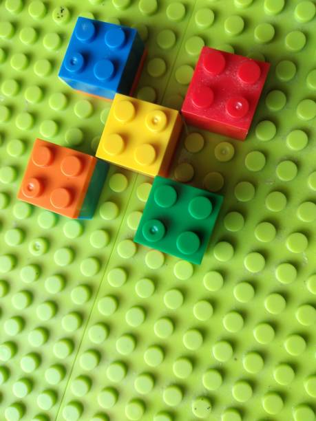 istock Plastic Colorful Construction and Building Blocks on Green Baseplate. 1906968395
