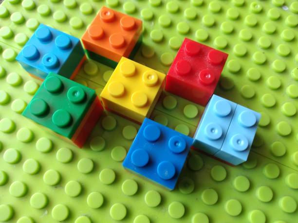 istock Plastic Colorful Construction and Building Blocks on Green Baseplate. 1906968899