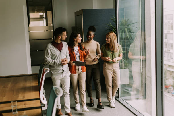 istock Young multiethnic startup team walking in the modern office 1906989702