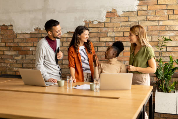 istock Young multiethnic startup team working by the brick wall in the industrial style office 1906989713