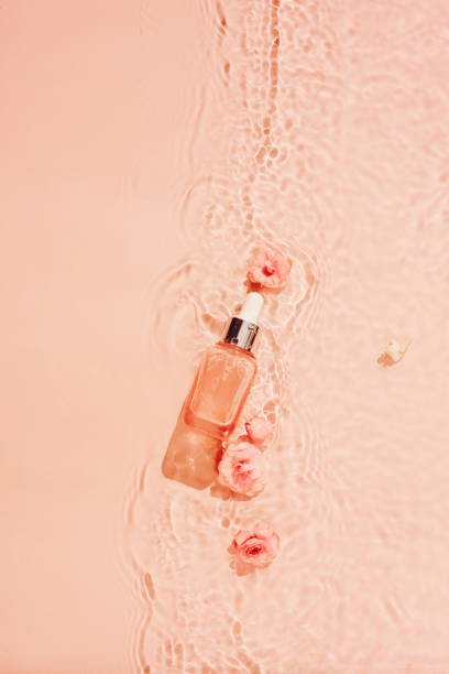 istock Spring water background with flowers and cosmetics 1906995893
