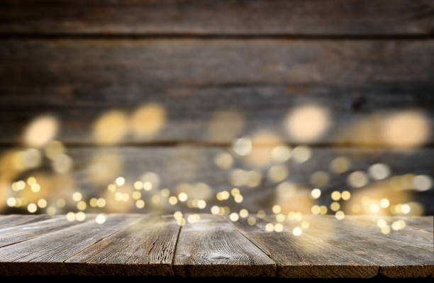 istock Empty rustic wooden table with blurred glitter lights background. Christmas lights on empty wooden table. Xmas holidays wallpaper. 1906999328