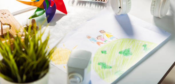 istock drawing family standing hold hands on planet earth on white paper 1907002212