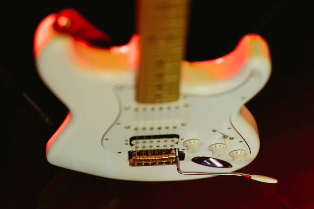 istock Closeup of a white electric guitar on a stand 1907012702
