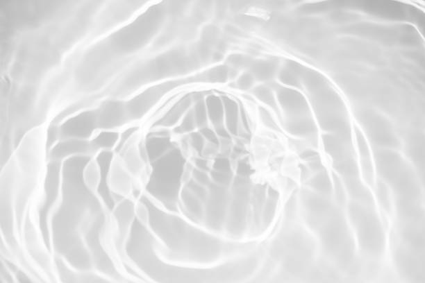 istock White water with ripples on the surface. Defocus blurred transparent white colored clear calm water surface texture with splashes and bubbles. Water waves with shining pattern texture background. 1907021666