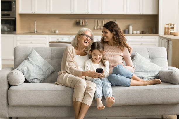 istock Happy pretty little tween kid girl using online application smartphone 1907023826