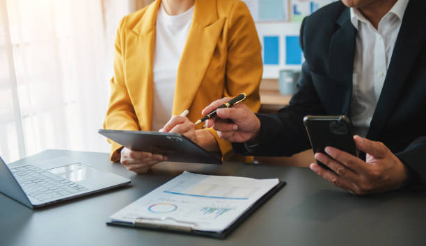 istock Business documents on office table with smart phone and calculator digital tablet and graph 1907033002