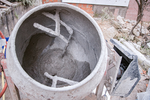 Cement mixing and making machine. Concrete mixer in action. Close up