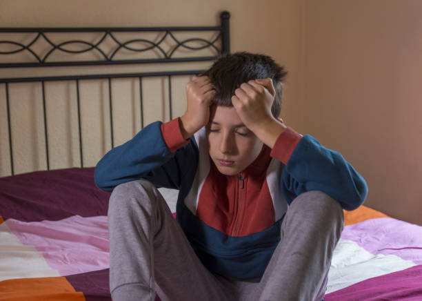 istock A boy dealing with depression, sadness, and feeling alone. Mental health and anxiety. Asking for help. Therapy and rehabilitation. Troubled teenager. 1907081431