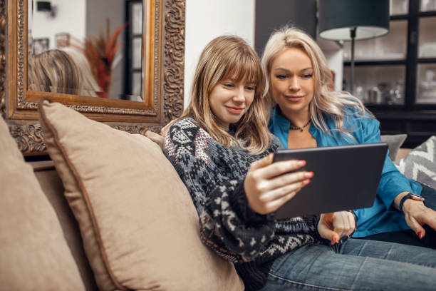 istock Mother and daughter using streaming devices at home 1907090895