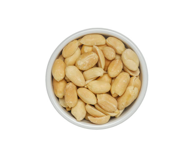 istock Small bowl of roasted salted peanuts isolated on white background. with Clipping path.From top view. 1907112846
