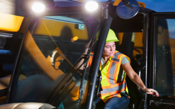 istock Hispanic woman at construction site operating machinery 1907136599